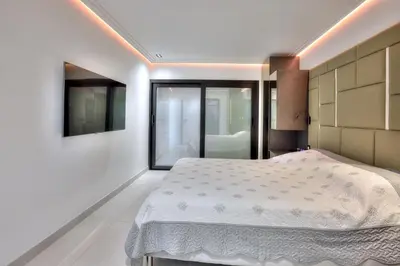a bedroom with a bed and a large window at Luxury 4 Stars Apt Croisette in Cannes