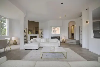 a living room with a white couch and a table at Twin Luxurious Villas 8 BR Pool in Vallauris in Vallauris