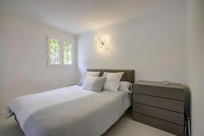 a white bedroom with a large bed and a window at Twin Luxurious Villas 8 BR Pool in Vallauris in Vallauris