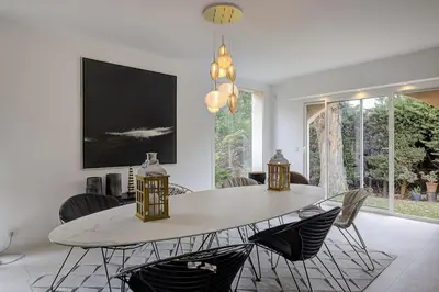 a dining room with a white table and chairs at Twin Luxurious Villas 8 BR Pool in Vallauris in Vallauris