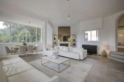 a living room with a white couch and a table at Twin Luxurious Villas 8 BR Pool in Vallauris in Vallauris