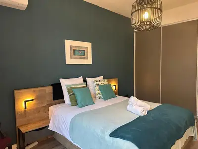 a bedroom with a large bed with two pillows at Dolce Cannes Riviera Cannes in Cannes