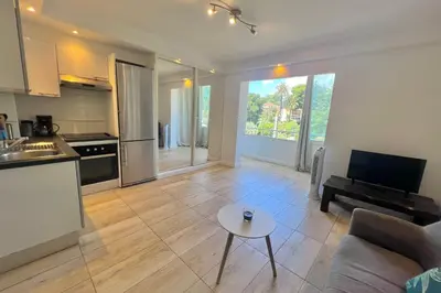 a kitchen and living room with a couch and a table at CANNES - STUDIO proximité Mer et commerces in Cannes