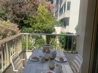 a white table with plates of food on a balcony at Studio AC with Balcony by Olidesi in Cannes