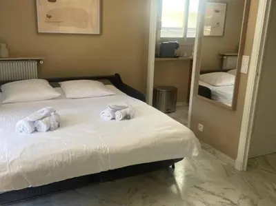 a bedroom with a bed with towels on it at Studio AC with Balcony by Olidesi in Cannes
