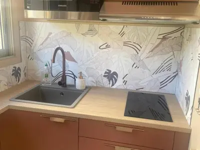a kitchen counter with a sink and a wall at Studio AC with Balcony by Olidesi in Cannes