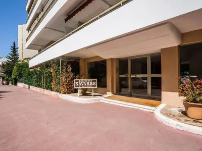 a sign in front of a building with a wanted sign at Studio AC with Balcony by Olidesi in Cannes