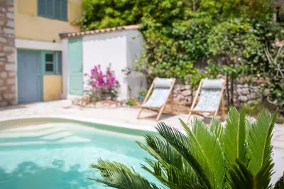 two chairs sitting next to a swimming pool at C8 - Lovely House Cannes 4 BDR - Pool, AC, Garage & Wifi in Cannes