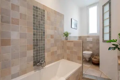 a bathroom with a tub and a toilet at C8 - Lovely House Cannes 4 BDR - Pool, AC, Garage & Wifi in Cannes