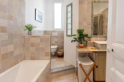 a bathroom with a tub and a toilet and a sink at C8 - Lovely House Cannes 4 BDR - Pool, AC, Garage & Wifi in Cannes