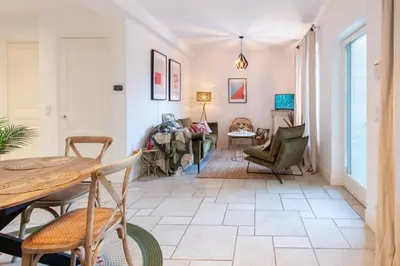 a living room with a table and chairs at C8 - Lovely House Cannes 4 BDR - Pool, AC, Garage & Wifi in Cannes