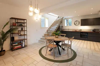a kitchen and dining room with a table and a staircase at C8 - Lovely House Cannes 4 BDR - Pool, AC, Garage & Wifi in Cannes