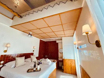 a hotel room with a bed and a table at Maison LYO logement Luxe in Cannes