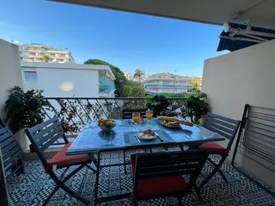 a table with food and drinks on a balcony at Beau Soleil Standing Presta in Cannes