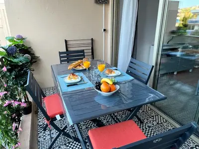 a table with a bowl of fruit and glasses of orange juice at Beau Soleil Standing Presta in Cannes