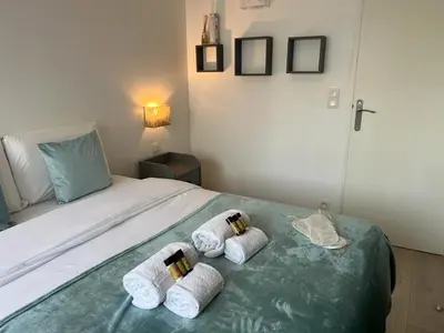 a bedroom with a bed with towels on it at Beau Soleil Standing Presta in Cannes