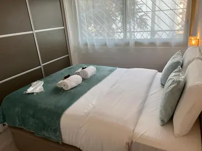 two towels on top of a bed with a window at Beau Soleil Standing Presta in Cannes