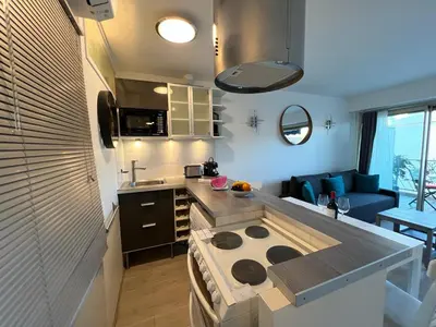 a kitchen with a stove top oven in a room at Beau Soleil Standing Presta in Cannes