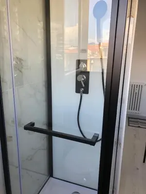 a glass shower door with a phone on it at Marble elegancy in Cannes center in Cannes