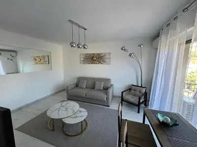 a living room with a couch and a table at Marble elegancy in Cannes center in Cannes