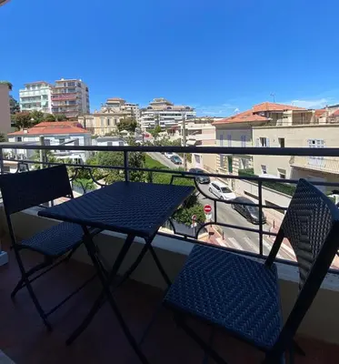a blue table and chairs on a balcony with a view at Marble elegancy in Cannes center in Cannes