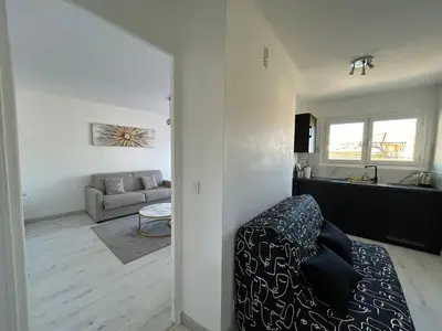 a living room with a couch and a table in a room at Marble elegancy in Cannes center in Cannes