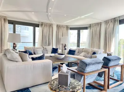 a living room with a couch and a table at Cannes Croisette 4 chambres luxe - 7C in Cannes