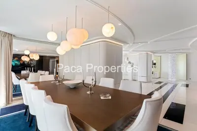 a dining room with a table and white chairs at Cannes Croisette 4 chambres luxe - 7C in Cannes