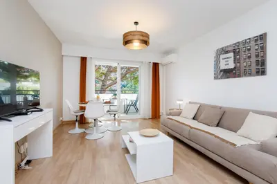a living room with a couch and a table at Studio très spacieux et Design LE BELLA Climatisé in Cannes
