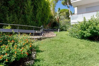 a garden with stairs and flowers next to a building at Studio très spacieux et Design LE BELLA Climatisé in Cannes