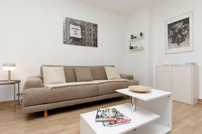 a living room with a couch and a table at Studio très spacieux et Design LE BELLA Climatisé in Cannes