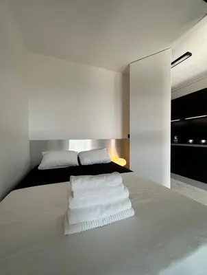 a bedroom with a bed with white towels on it at Appartement Design élégant in Le Cannet
