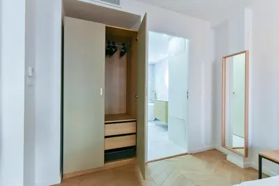 a hallway with white walls and a large mirror at Hypercentre - 5mn croisette - Palais - Plage - CF in Cannes