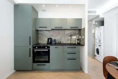 a kitchen with a stove and a refrigerator at Hypercentre - 5mn croisette - Palais - Plage - CF in Cannes