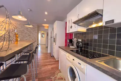 a kitchen with a sink and a counter top at LE SURCOUF Appartement by 4 By SUNSET in Le Cannet