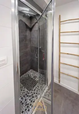 a shower with a glass door in a bathroom at LE SURCOUF Appartement by 4 By SUNSET in Le Cannet