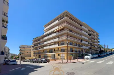 a tall building with cars parked in a parking lot at LE SURCOUF Appartement by 4 By SUNSET in Le Cannet