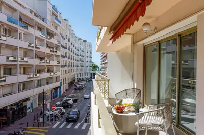 a bedroom with a large bed and a couch at Premium 80sqm Apartment Opposite Martinez, Steps from Congress Center in Cannes