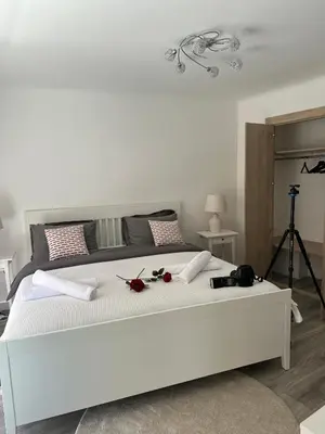 a living room with a large tv and a chair at Premium 80sqm Apartment Opposite Martinez, Steps from Congress Center in Cannes