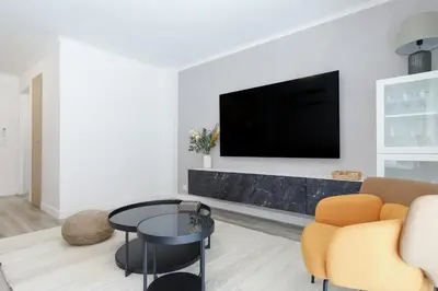 a bedroom with a bed with a ceiling fan at Premium 80sqm Apartment Opposite Martinez, Steps from Congress Center in Cannes