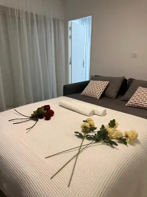 a kitchen with white cabinets and black counter tops at Premium 80sqm Apartment Opposite Martinez, Steps from Congress Center in Cannes