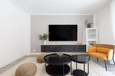 a large building with a row of lights in the water at Premium 80sqm Apartment Opposite Martinez, Steps from Congress Center in Cannes