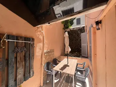 a table and chairs on the balcony of a building at B031 2 chambres 6 personnes terrasse au centre historique in Cannes