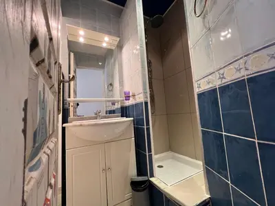 a small bathroom with a sink and a shower at B031 2 chambres 6 personnes terrasse au centre historique in Cannes