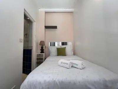 a bedroom with a bed with two towels on it at B031 2 chambres 6 personnes terrasse au centre historique in Cannes