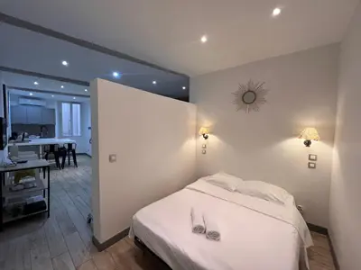 a bedroom with a bed with shoes on it at B032 Grand studio au marche Forville in Cannes
