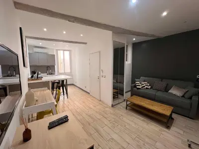 a living room with a couch and a table at B032 Grand studio au marche Forville in Cannes