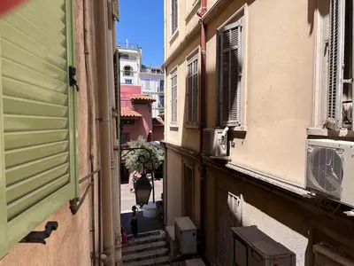 an alley with stairs and buildings in a city at B032 Grand studio au marche Forville in Cannes