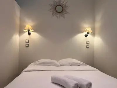 a bedroom with a bed with two towels on it at B032 Grand studio au marche Forville in Cannes