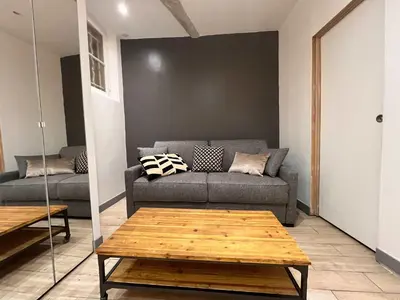 a living room with a couch and a coffee table at B032 Grand studio au marche Forville in Cannes